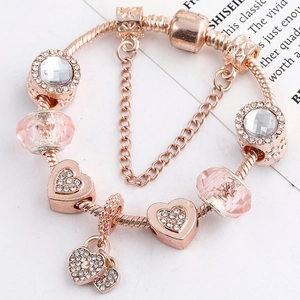 Rose gold charm bracelet with pink crystal beads and heart pendants on snake chain