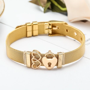 Detail of golden mesh strap bracelet featuring heart charms and watch-style buckle