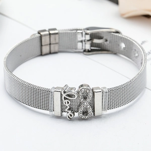 Detail of silver mesh bracelet with Love charm and infinity symbol on white surface