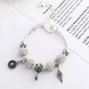 Detail of silver-plated snake chain bracelet with ice cream charm and heart extender