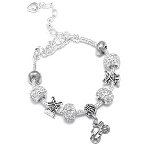 Detailed view of silver charm bracelet with windmill pendants and heart extension chain