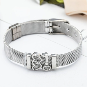 Close-up of silver mesh bracelet featuring double heart and key charms with buckle clasp