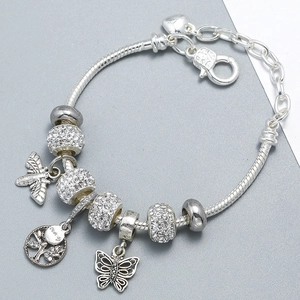 Detailed macro view of silver charm bracelet with family tree pendant and heart chain extender