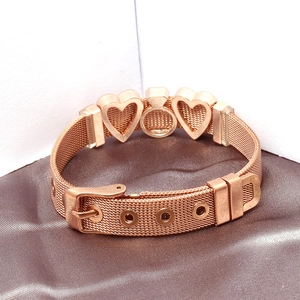 Detail of rose gold snake bone mesh bracelet with heart charms and buckle closure