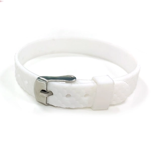 Macro view of white silicone watch band showing honeycomb texture and metal pin buckle clasp