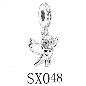 Silver owl charm pendant with wings spread holding an envelope with red enamel seal