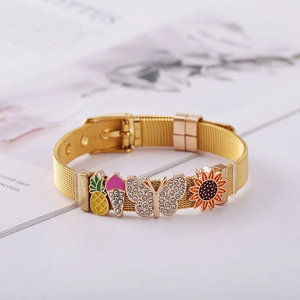 Detail of gold stainless steel mesh bracelet with pineapple and flower charms