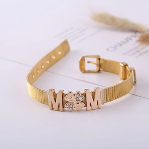 Detail of golden mesh watch-style bracelet with rhinestone MOM clover and M letters