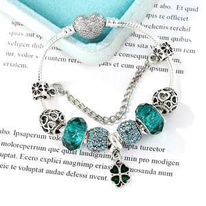 Green emerald beads and silver snake chain heart charm bracelet in an elegant gift box