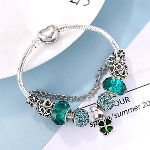 Silver snake chain bracelet with heart clasp, green glass beads and clover pendant