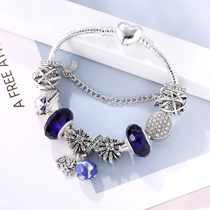 Vintage Thai silver charm bracelet with blue beads, heart pendant and globe charm