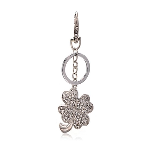 Silver four-leaf clover keychain with white rhinestones and secure lobster clasp on white background
