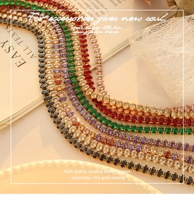 Macro shot of surgical titanium steel necklaces with colorful oval-cut zircon gems on lace