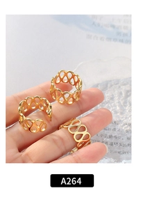 Close-up of three gold hollow teardrop rings showing intricate geometric link textures