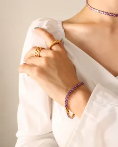 Detail shot of a French vintage 18k gold plated set with purple oval zircon gemstones