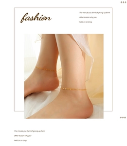 Close-up of a minimalist golden water wave chain anklet worn on an ankle