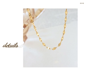 Macro shot of gold-plated titanium steel fish-mouth link chain with elegant leaf-shaped links