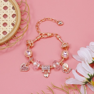 Detailed view of rose gold charm bracelet with pink crystals and heart butterfly charms