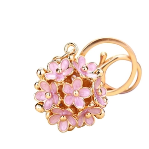 Pink daisy flower ball keychain with 3D hollow petals and gold finish for bags