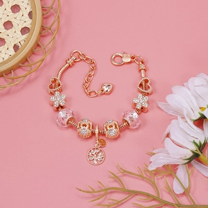 Detailed macro view of rose gold snake chain bracelet with life tree charm and floral beads