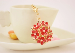 Detail of red enamel daisy flower ball keychain with gold finish lobster clasp