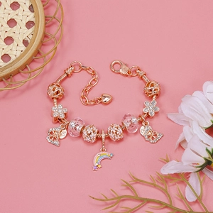 Detail of rose gold beaded bracelet with colorful rainbow pendant and floral charms