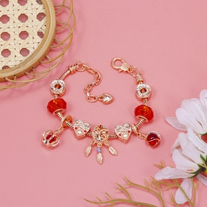 Detailed macro view of rose gold crown and heart charms on a crystal beaded bracelet