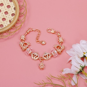 Rose gold snake chain charm bracelet with crown, heart, and pumpkin carriage pendants