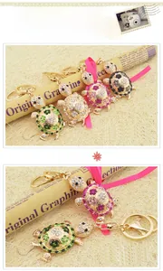 Detail of colorful rhinestone tortoise keychains in gold, pink, and green crystal finishes