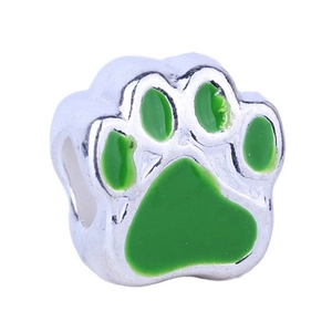 Macro detail of silver paw bead with green enamel finish for charm bracelets