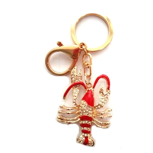 Porte-clés homard scintillant avec émail rouge et strass sur base en métal doré