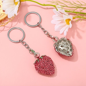 Macro view of sparkly pink strawberry rhinestone keychain with silver hollow metal backing