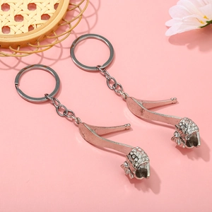 Close-up of silver high heel keychains with sparkling rhinestones and bow detailing