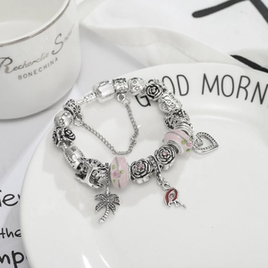 Bracelet perles en verre rose avec breloques flamant rose palmier et cœur en argent 925