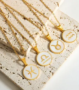 Detail of zodiac signs pendants with white shell inlay and gold plating on stone
