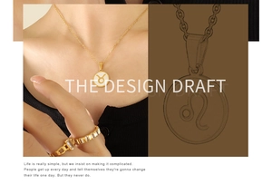 Macro view of gold zodiac necklace design draft with Taurus pendant and gemstone ring