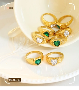 Macro view of vintage heart-shaped gemstone rings with gold-plated embossed textures