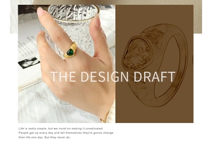 Detailed design draft and hand view of a heart-shaped green stone ring with textured gold band