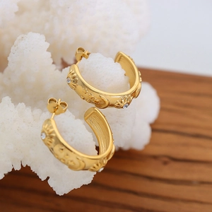 Star and moon relief gold-plated C-shaped hoop earrings with sparkling cubic zirconia