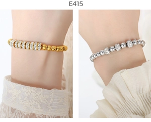 Detail of hip hop style heart link bracelets in gold and silver with inlaid rhinestones