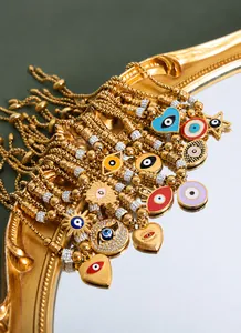 Detailed close-up of 18K gold-plated Evil Eye bracelets with colorful enamel charms