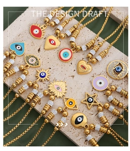 Detailed macro view of 18K gold plated evil eye charms with vibrant enamel inlay