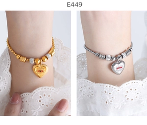 Detail of 18K gold and silver bracelets featuring heart-shaped evil eye charms
