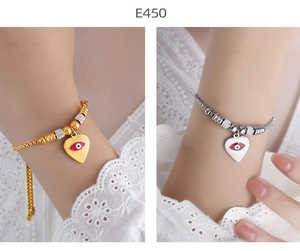 Detail of heart-shaped evil eye bracelets in gold and silver finish with sparkling beads