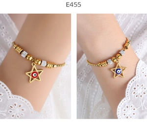 Detail of 18K gold plated evil eye star charm bracelets with pave rhinestones