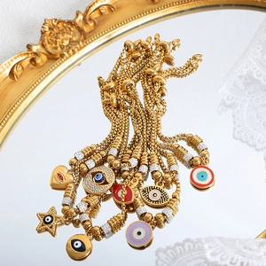Vintage 18K gold plated evil eye bracelets with colorful enamel charms on mirror surface