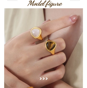 Close-up of vintage style 18k gold plated rings with tiger eye and moonstone gems