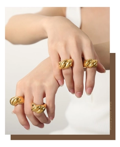 Macro shot of 18k gold plated twisted wave stackable rings with high polish finish