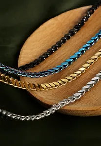 Macro shot of titanium steel woven chains in silver, gold, rainbow, and black finishes