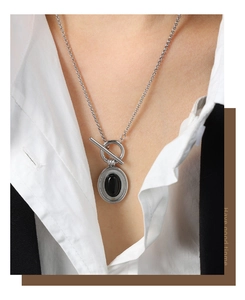 Détail du collier à fermoir OT avec pendentif ovale en agate noire sur chaîne argentée
